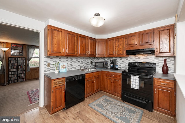 617 March St, Reading, PA 19607 - kitchen featuring black appliances, under cabinet range hood, light wood-style flooring, and brown cabinets