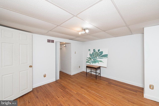 617 March St, Reading, PA 19607 - finished below grade area with a paneled ceiling, light wood-type flooring, and baseboards
