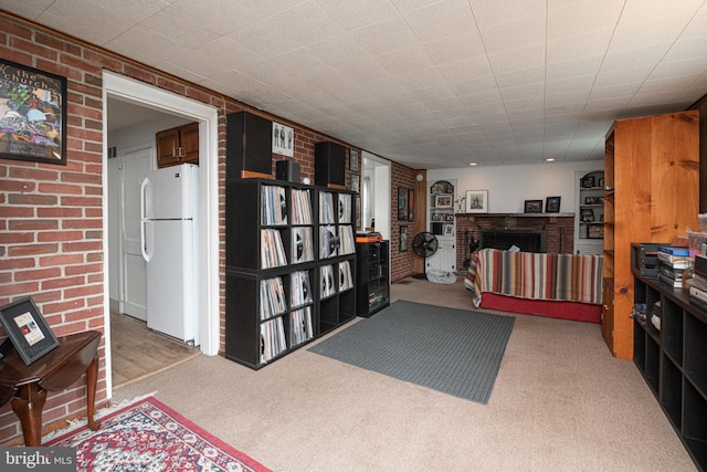 617 March St, Reading, PA 19607 - kitchen featuring freestanding refrigerator, carpet, brick wall, and a brick fireplace