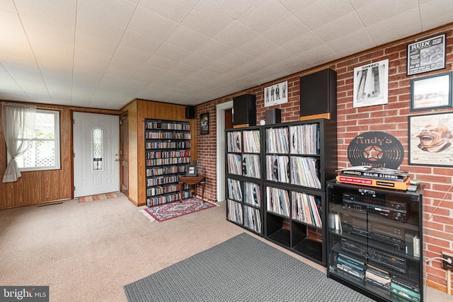 617 March St, Reading, PA 19607 - foyer with carpet flooring, wood walls, and brick wall