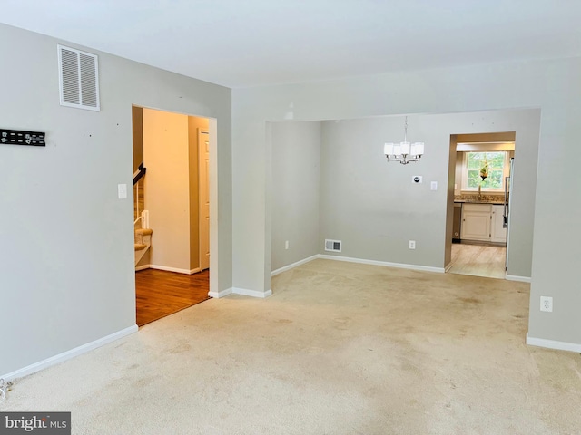 5431 Plymouth Meadows Ct, Fairfax, VA 22032 - empty room featuring light colored carpet, a chandelier, baseboards, and a sink