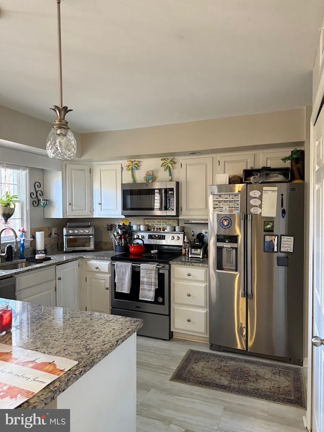 5431 Plymouth Meadows Ct, Fairfax, VA 22032 - kitchen featuring appliances with stainless steel finishes, a sink, white cabinets, light stone countertops, and hanging light fixtures