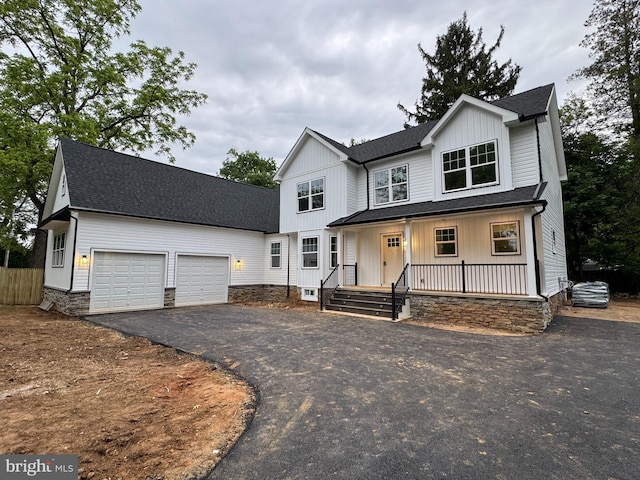 1 Glenwood Cir, Media, PA 19063 - modern inspired farmhouse featuring a shingled roof, asphalt driveway, a porch, an attached garage, and board and batten siding