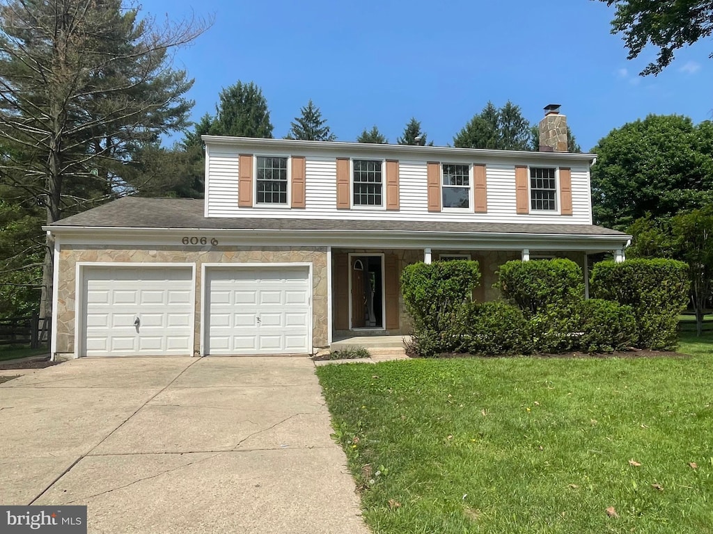 6066 Camelback Ln, Columbia, MD 21045 - traditional-style home featuring a chimney, driveway, a front yard, and a garage
