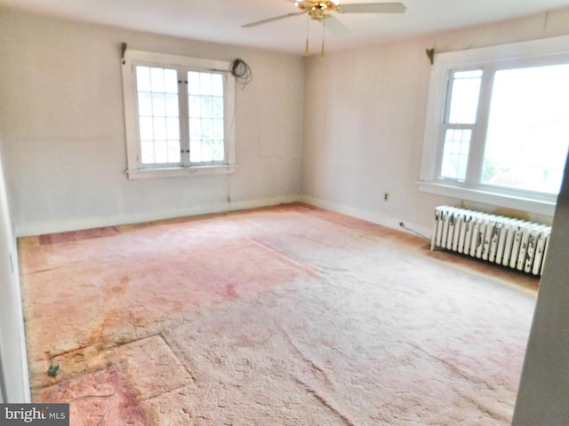 1216 23rd Ave, Altoona, PA 16601 - carpeted empty room with radiator heating unit, a ceiling fan, and baseboards