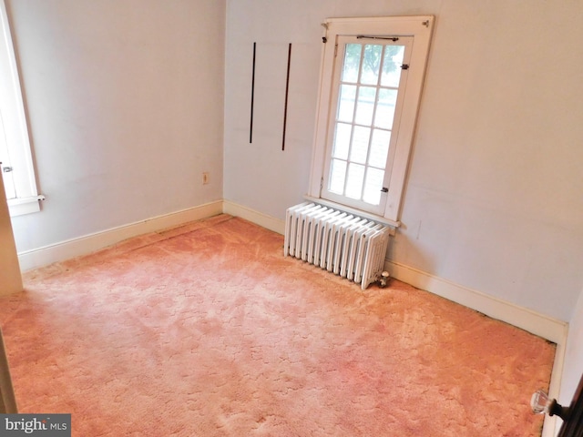 1216 23rd Ave, Altoona, PA 16601 - carpeted empty room with radiator heating unit and baseboards