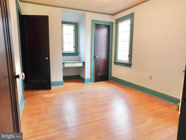 1216 23rd Ave, Altoona, PA 16601 - unfurnished bedroom with wood finished floors, multiple windows, baseboards, and crown molding