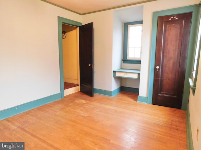 1216 23rd Ave, Altoona, PA 16601 - spare room featuring wood finished floors, ornamental molding, baseboards, and a desk