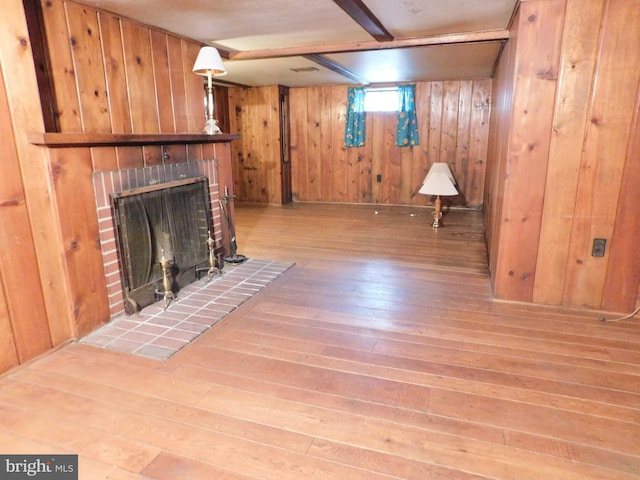 1216 23rd Ave, Altoona, PA 16601 - unfurnished living room featuring hardwood / wood-style floors, wood walls, and a fireplace
