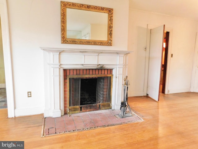 1216 23rd Ave, Altoona, PA 16601 - detailed view of wood finished floors, baseboards, and a brick fireplace