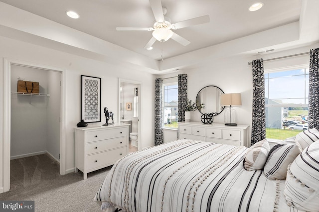 2505 Boeing Way, Cambridge, MD 21613 - bedroom featuring light carpet, a walk in closet, recessed lighting, baseboards, and a tray ceiling