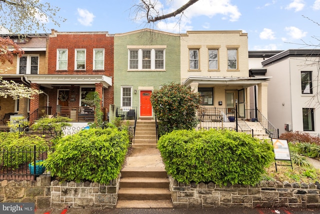 111 17th St SE, Washington, DC 20003 - view of property featuring brick siding, covered porch, and stairway