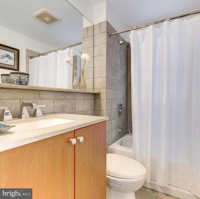 1121 24th St NW Unit 309, Washington, DC 20037 - bathroom featuring vanity, toilet, tile patterned floors, shower / bath combo, and tile walls