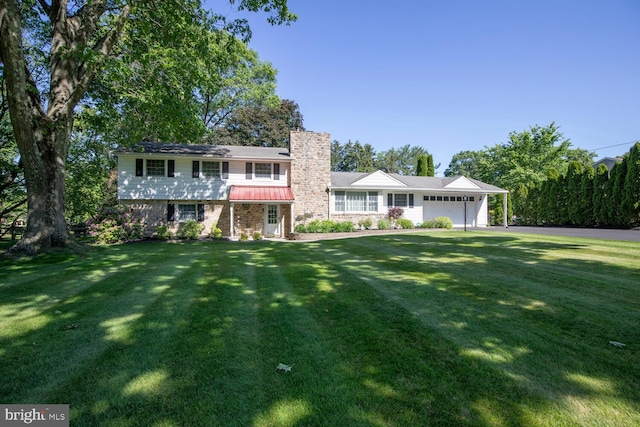 128 Cherry Ln, Doylestown, PA 18901 - view of front of home featuring a chimney, a front lawn, and an attached garage