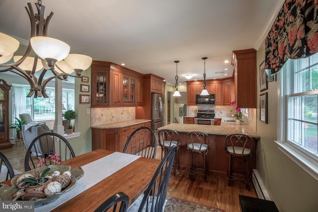 128 Cherry Ln, Doylestown, PA 18901 - dining room with healthy amount of natural light, wood finished floors, recessed lighting, baseboard heating, and a chandelier