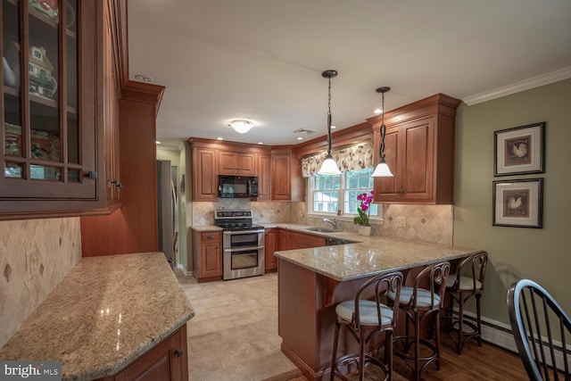 128 Cherry Ln, Doylestown, PA 18901 - kitchen featuring stainless steel appliances, a sink, a peninsula, brown cabinets, and ornamental molding