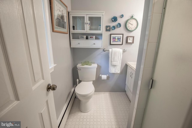 128 Cherry Ln, Doylestown, PA 18901 - full bathroom with baseboard heating, toilet, vanity, and baseboards