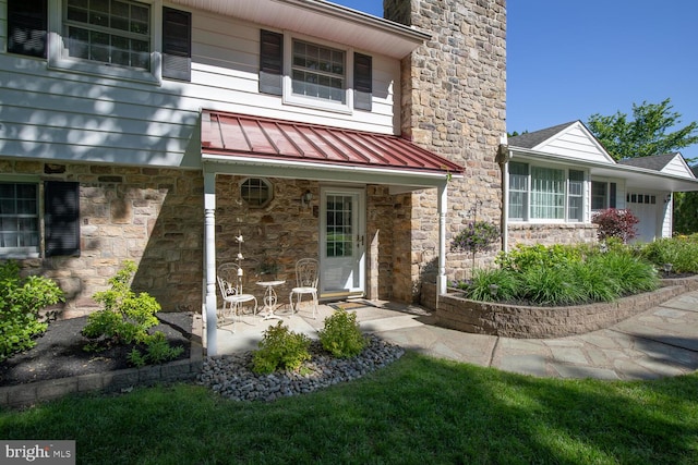 128 Cherry Ln, Doylestown, PA 18901 - doorway to property featuring stone siding, a standing seam roof, a chimney, and metal roof