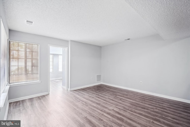 14011 Justin Way Unit 21-A, Laurel, MD 20707 - unfurnished room with a textured ceiling, wood finished floors, and baseboards