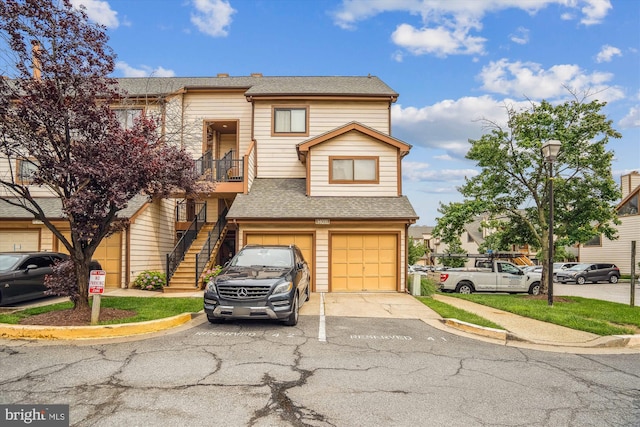 14011 Justin Way Unit 21-A, Laurel, MD 20707 - townhome / multi-family property with stairway, driveway, a garage, and a shingled roof