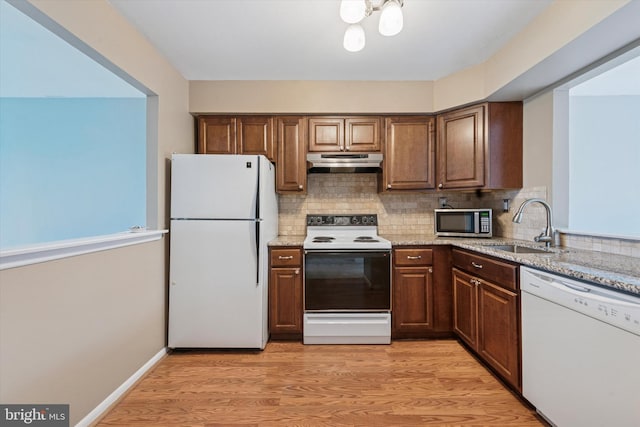 289 Summit House Unit 289, West Chester, PA 19382 - kitchen with white appliances, under cabinet range hood, a sink, and decorative backsplash