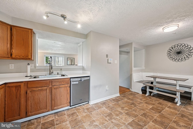 8924 Oxley Forest Ct, Laurel, MD 20723 - kitchen with dishwasher, brown cabinets, a textured ceiling, and light countertops