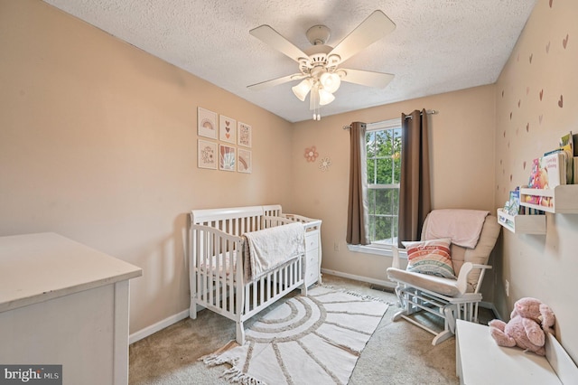 8924 Oxley Forest Ct, Laurel, MD 20723 - carpeted bedroom with a textured ceiling, a crib, and ceiling fan