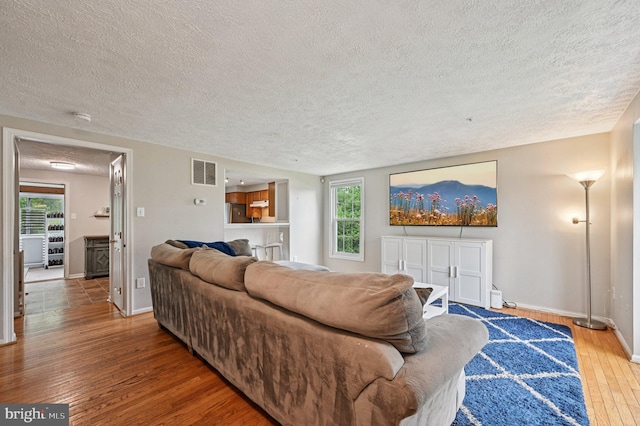 8924 Oxley Forest Ct, Laurel, MD 20723 - living area with a textured ceiling, hardwood / wood-style flooring, and plenty of natural light