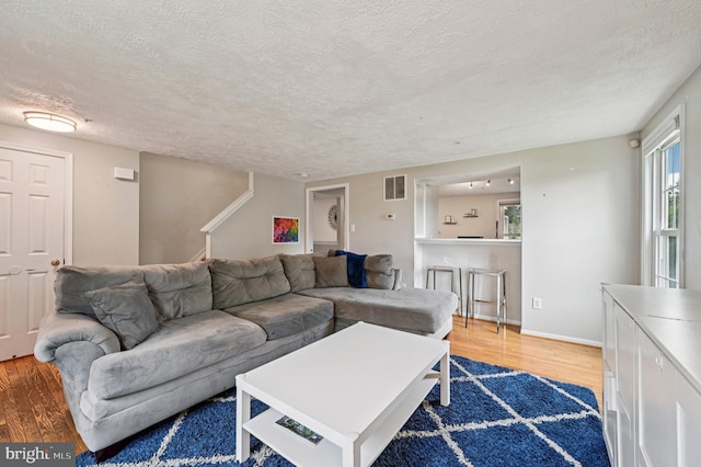 8924 Oxley Forest Ct, Laurel, MD 20723 - living area with wood finished floors, a textured ceiling, and stairway