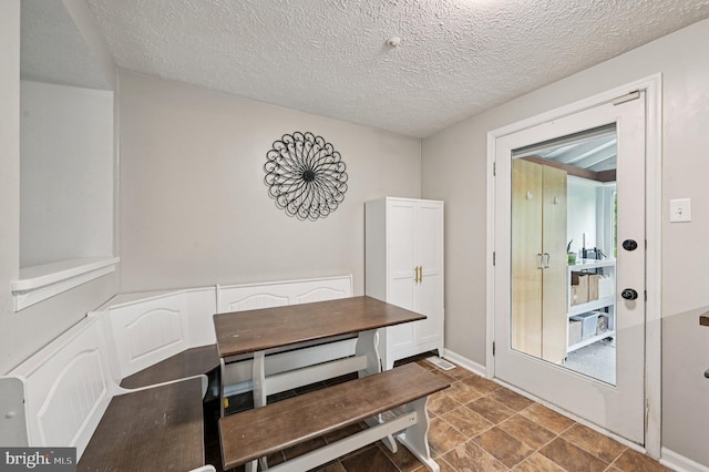 8924 Oxley Forest Ct, Laurel, MD 20723 - unfurnished dining area featuring a textured ceiling