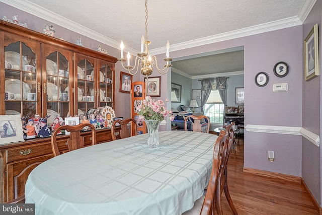 618 Walden Way, Lumberton, NJ 08048 - dining space featuring wood finished floors, a chandelier, ornamental molding, baseboards, and a textured ceiling