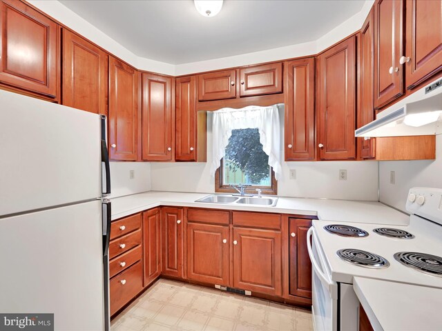 16 W Maple Ave, Myerstown, PA 17067 - kitchen featuring white appliances, a sink, under cabinet range hood, light countertops, and brown cabinets