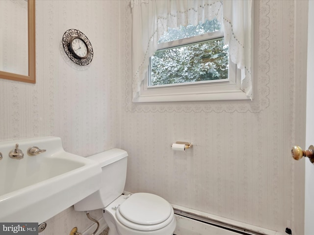 16 W Maple Ave, Myerstown, PA 17067 - half bath featuring baseboard heating, a sink, toilet, and wallpapered walls