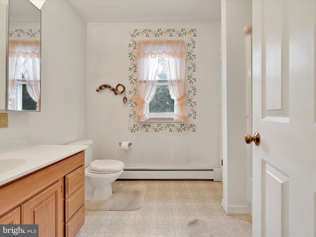 16 W Maple Ave, Myerstown, PA 17067 - bathroom with baseboard heating, vanity, toilet, and tile patterned floors