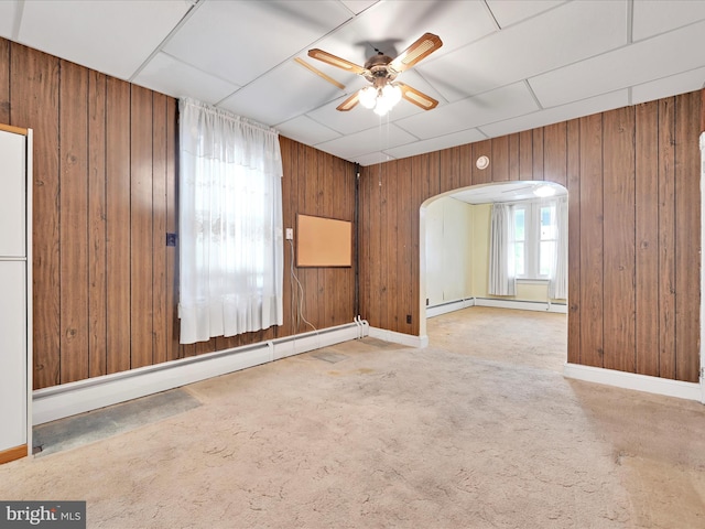 16 W Maple Ave, Myerstown, PA 17067 - carpeted spare room featuring arched walkways, a ceiling fan, wood walls, baseboards, and baseboard heating