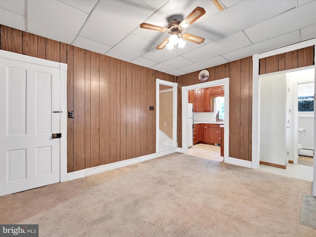 16 W Maple Ave, Myerstown, PA 17067 - unfurnished bedroom featuring wood walls, connected bathroom, light colored carpet, freestanding refrigerator, and a baseboard heating unit