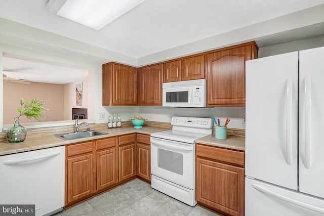 9147 Everett Ct, Springfield, VA 22152 - kitchen featuring white appliances, light countertops, and brown cabinetry