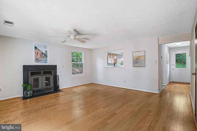 9147 Everett Ct, Springfield, VA 22152 - unfurnished living room with a ceiling fan, light wood finished floors, and a wood stove