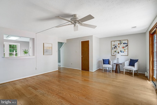 9147 Everett Ct, Springfield, VA 22152 - sitting room featuring light wood-style floors, ceiling fan, and a textured ceiling
