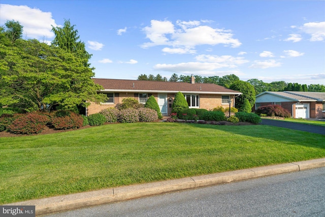 464 E Walnut St, Kutztown, PA 19530 - ranch-style home featuring brick siding, a front yard, and a chimney