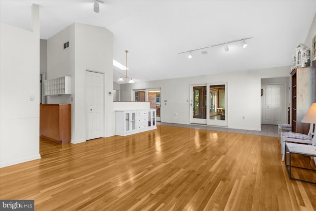 464 E Walnut St, Kutztown, PA 19530 - unfurnished living room with track lighting, baseboards, light wood-style floors, and high vaulted ceiling