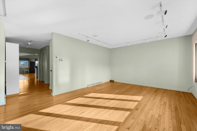 464 E Walnut St, Kutztown, PA 19530 - unfurnished room featuring rail lighting, wood finished floors, and baseboards