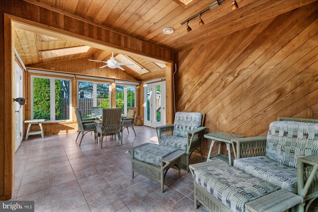 464 E Walnut St, Kutztown, PA 19530 - sunroom with wood ceiling, a skylight, wood walls, lofted ceiling, and plenty of natural light