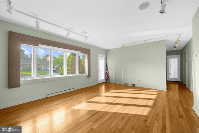 464 E Walnut St, Kutztown, PA 19530 - unfurnished room with rail lighting, a baseboard heating unit, plenty of natural light, and wood finished floors