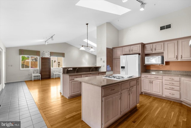 464 E Walnut St, Kutztown, PA 19530 - kitchen with track lighting, white appliances, a skylight, vaulted ceiling, and a kitchen island