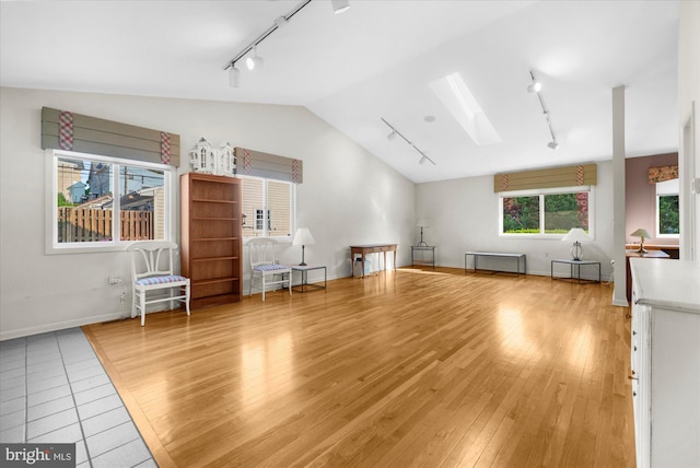 464 E Walnut St, Kutztown, PA 19530 - living room with track lighting, a skylight, lofted ceiling, light wood-type flooring, and baseboards
