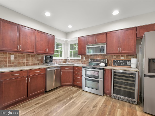 6290 Pinyon Pine Ct, Eldersburg, MD 21784 - kitchen with beverage cooler, appliances with stainless steel finishes, light wood-type flooring, tasteful backsplash, and recessed lighting