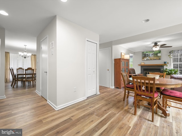 6290 Pinyon Pine Ct, Eldersburg, MD 21784 - dining room with a fireplace, light wood-style floors, a ceiling fan, a chandelier, and recessed lighting
