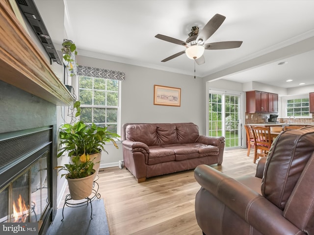 6290 Pinyon Pine Ct, Eldersburg, MD 21784 - living area featuring a glass covered fireplace, light wood-style floors, a ceiling fan, recessed lighting, and ornamental molding