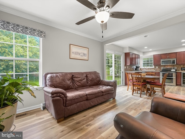 6290 Pinyon Pine Ct, Eldersburg, MD 21784 - living area featuring light wood finished floors, ceiling fan, crown molding, beverage cooler, and recessed lighting